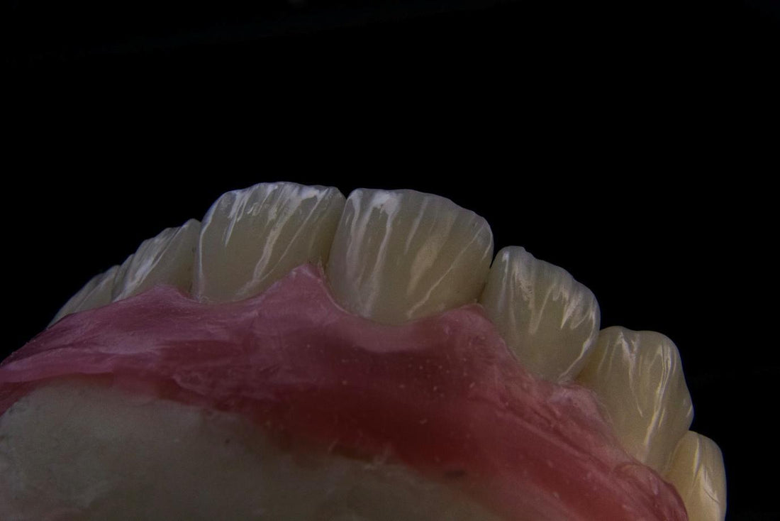a close up of a toothbrush with a pink substance on it