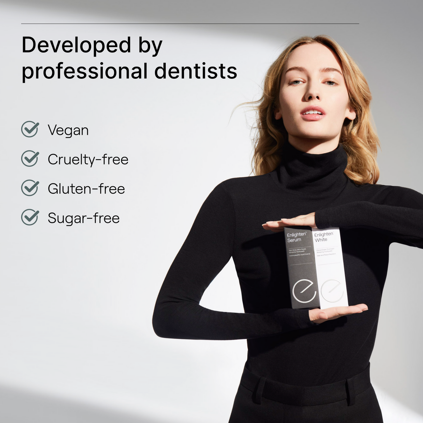 Woman holding Enlighten Serum and White displaying they are vegan, cruelty, gluten and sugar free