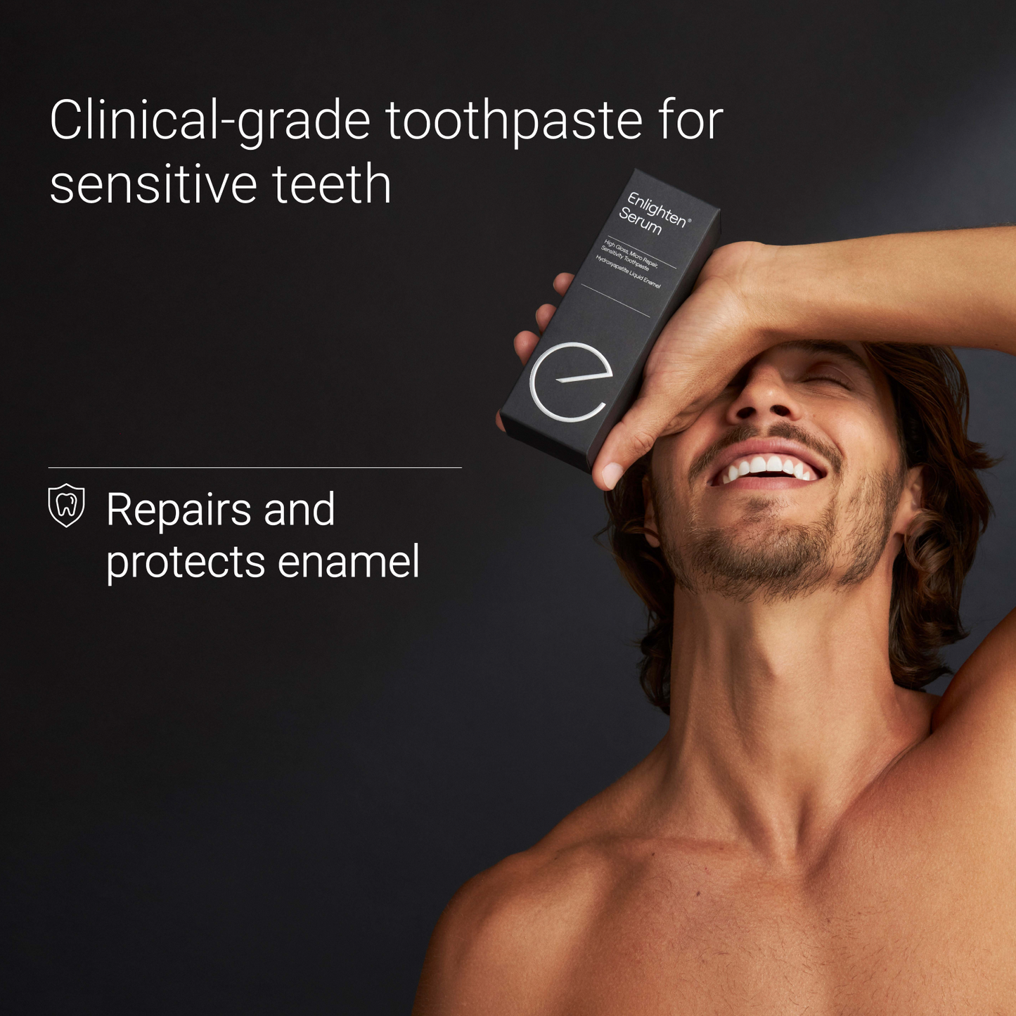 Man smiling holding the Enlighten Serum over his head highlighting it repairs and protects enamel