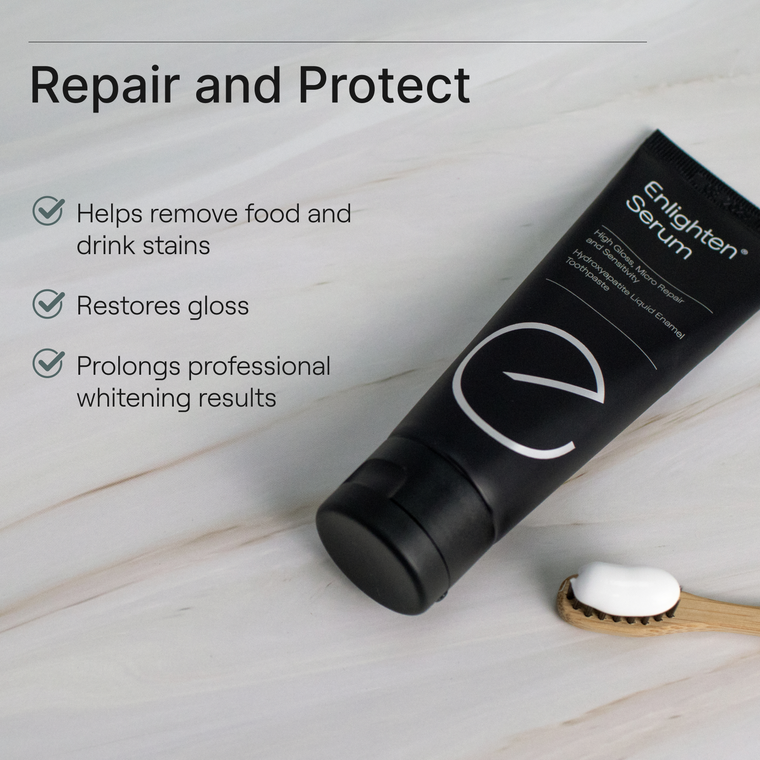 Enlighten Serum tube on marble surface with toothbrush, highlighting stain removal, gloss restoration, and prolonged whitening benefits