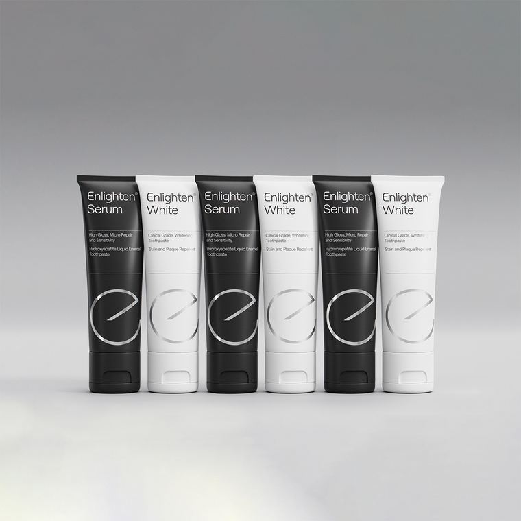 A lineup of Enlighten Serum and Enlighten White toothpaste tubes