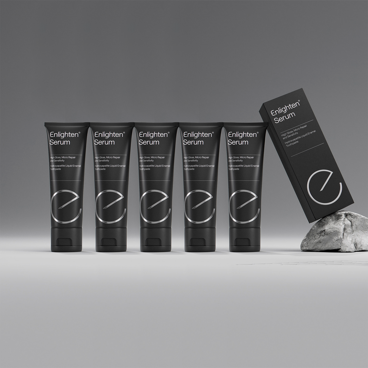 5 Enlighten Serum toothpaste tubes in a row with box