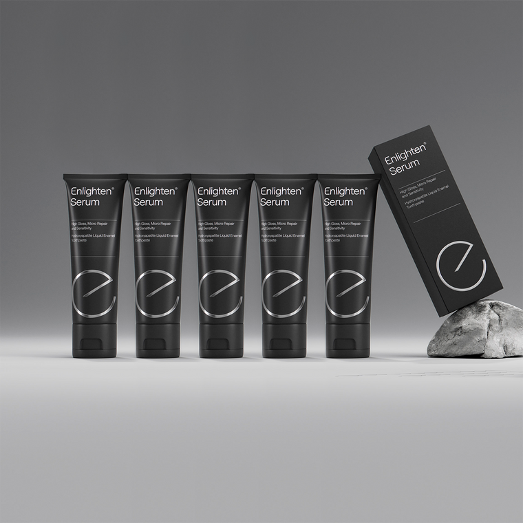 5 Enlighten Serum toothpaste tubes in a row with box