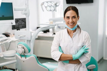 dentist in a dental practice room sitting near a dental chair